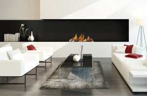 Modern living room with white sofas, a coffee table, and a fireplace.