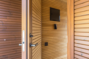 Wooden door with a mounted television inside a wooden structure