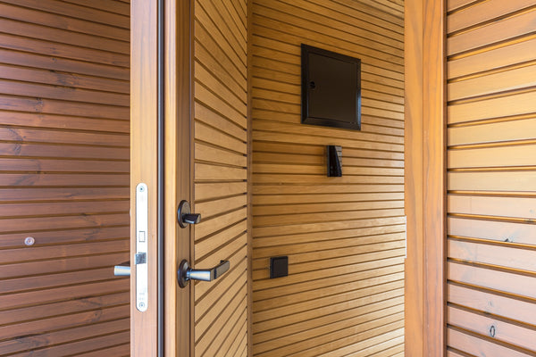 Wooden door with a mounted television inside a wooden structure