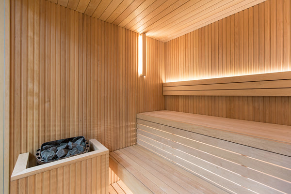 Wooden sauna with bench and bathtub