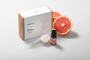 Grapefruit essential oil set with a box labeled 'saunum' on a light gray background