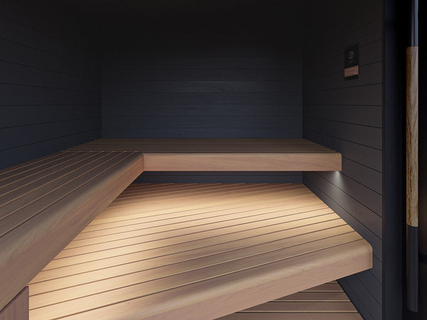 Wooden benches inside a dark wooden sauna