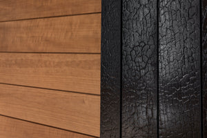 Close-up of wooden paneling and a cracked black surface